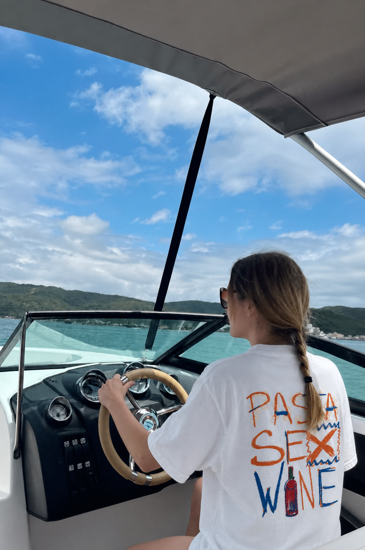 Pasta Sex Wine tee at the helm of a speedboat