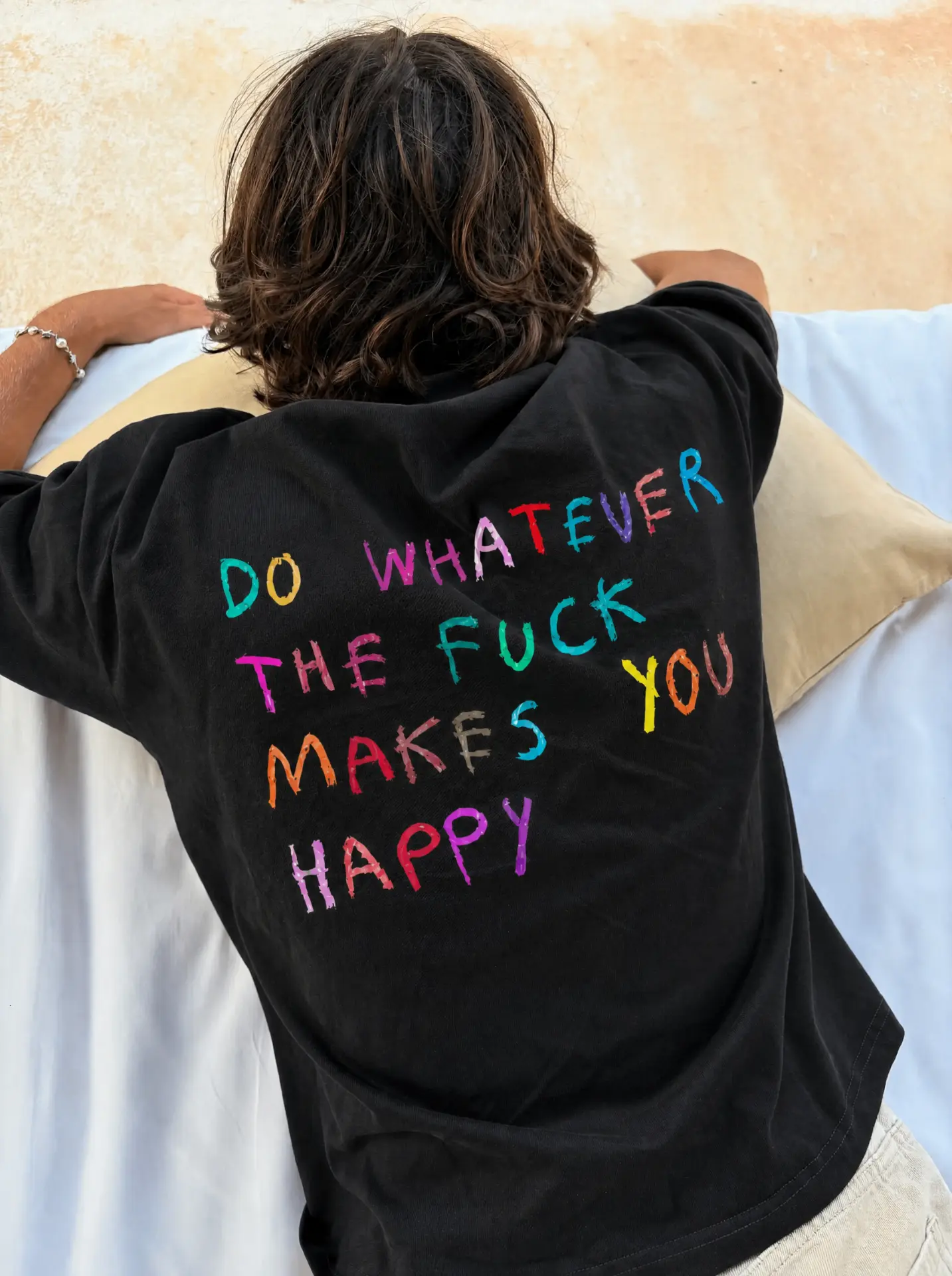 Do whatever the fuck makes you happy black tee against a villa wall