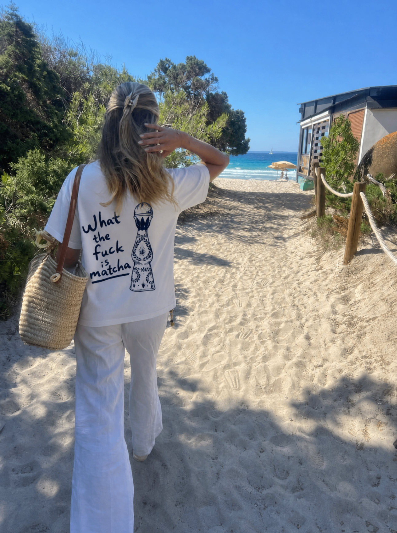 Matcha tee on a sandy beach path