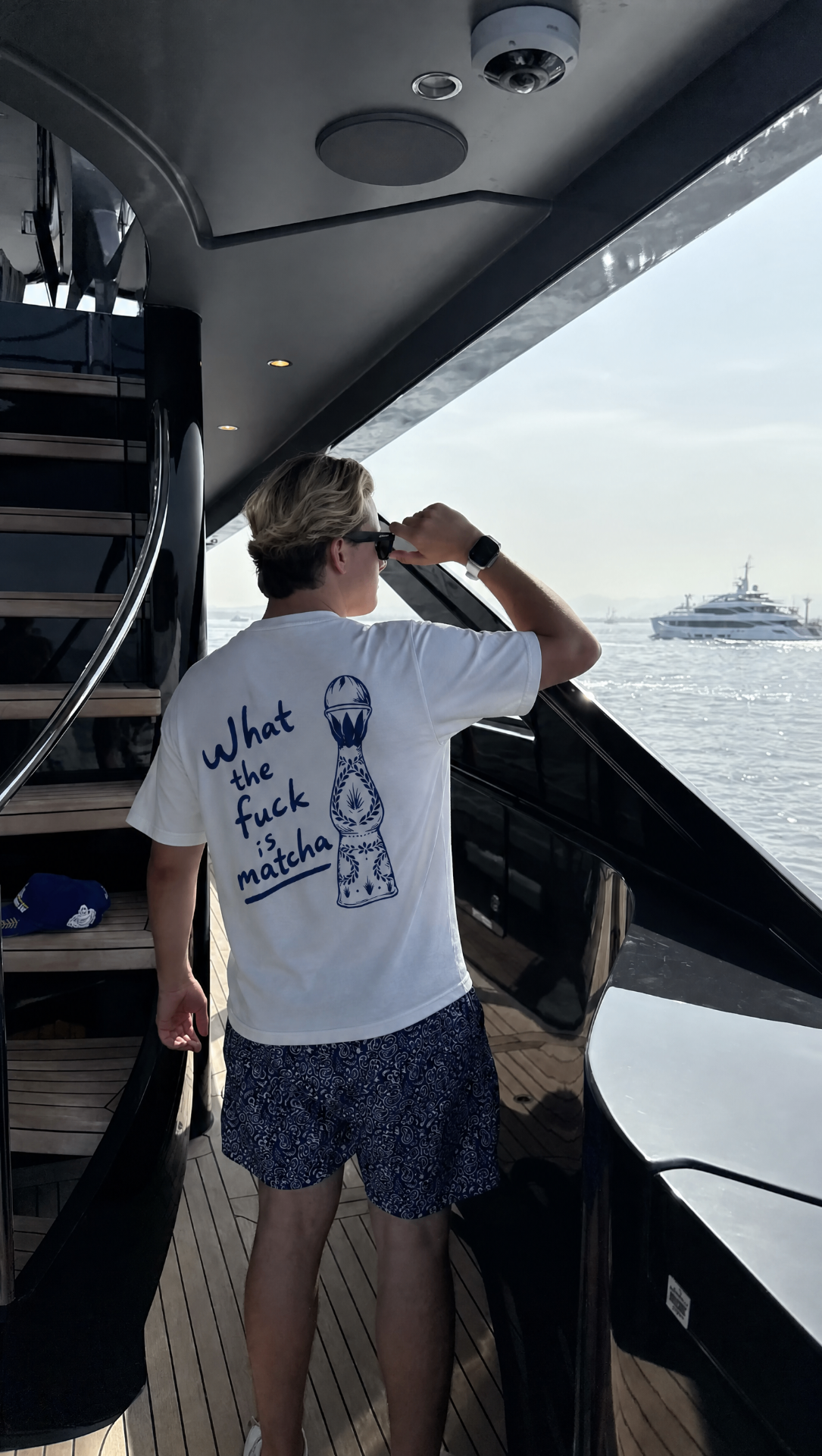 Matcha tee on a yacht deck, binoculars out